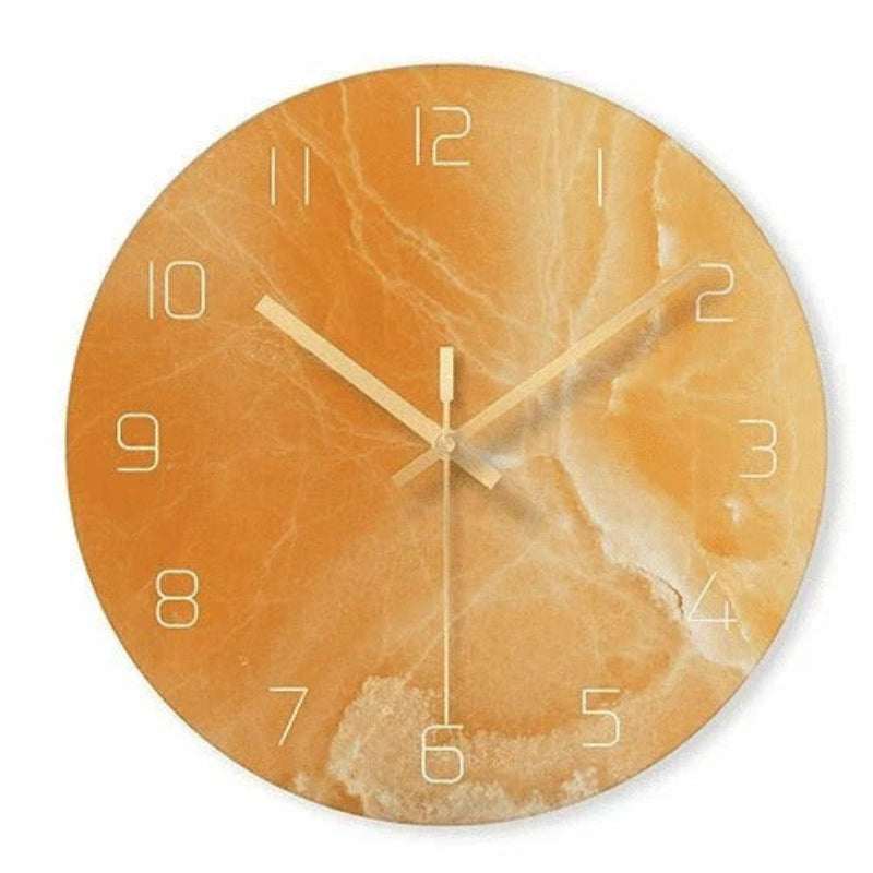Round wall clock with orange marble design on a white background