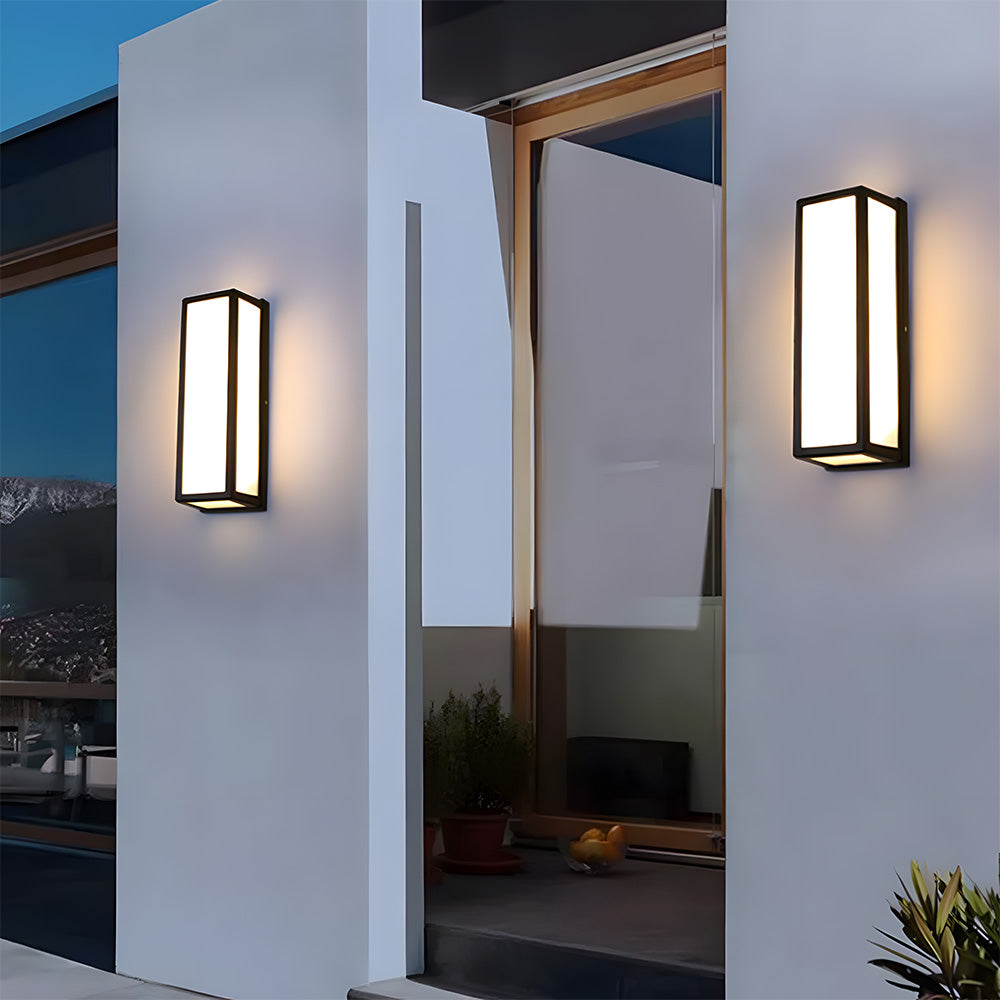 Modern outdoor wall lights on a building exterior with a view into a room.