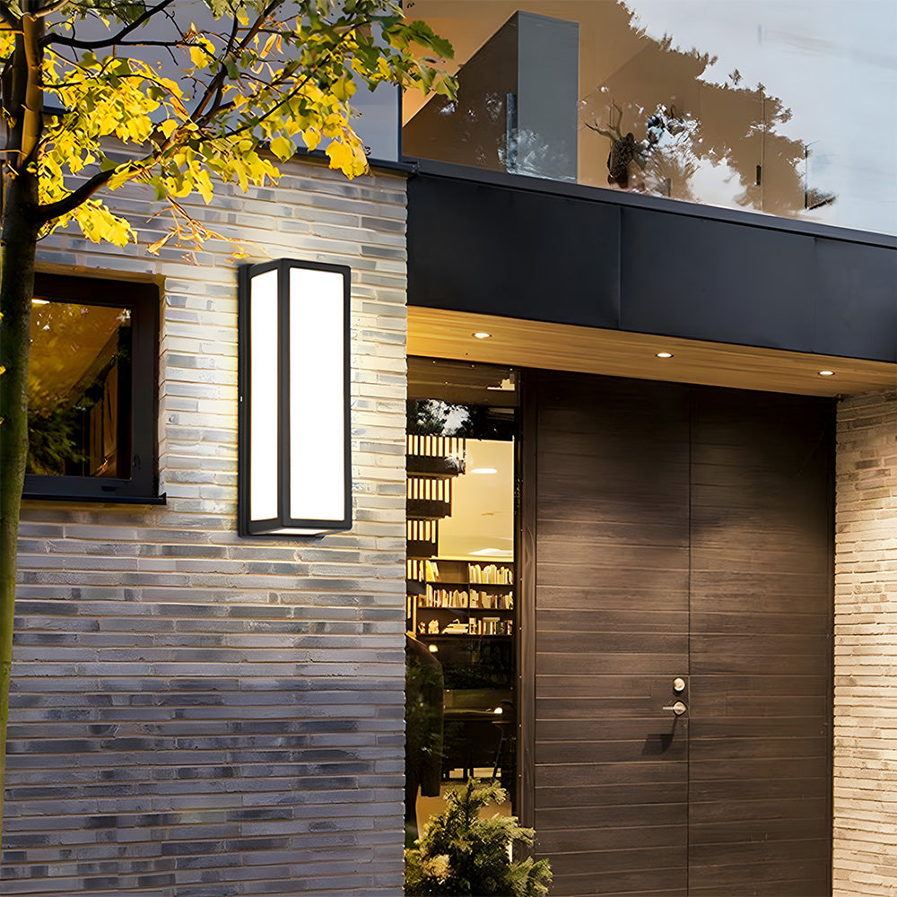 Modern house exterior with a door and wall-mounted light fixture.