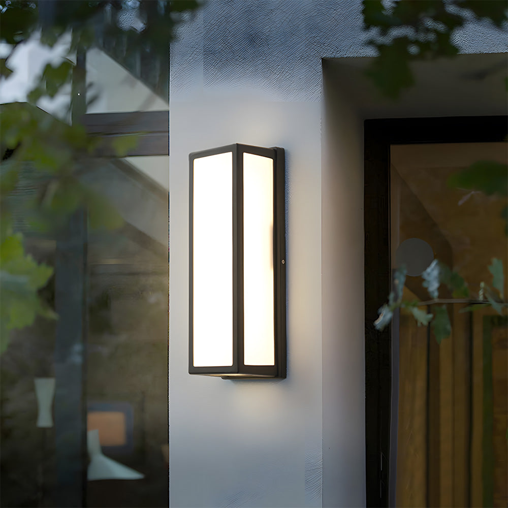 Outdoor wall light fixture on a building exterior with blurred background