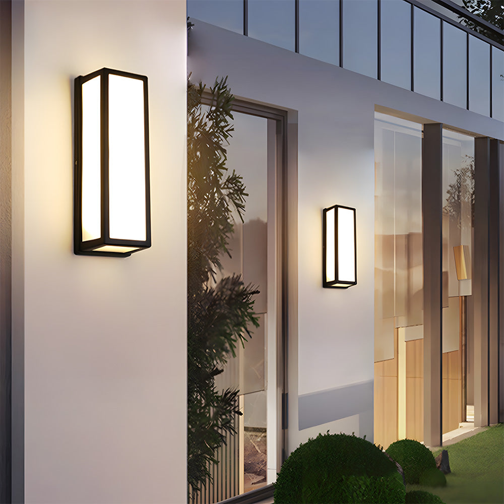 Modern outdoor wall lights on a building exterior with a view of a house interior.