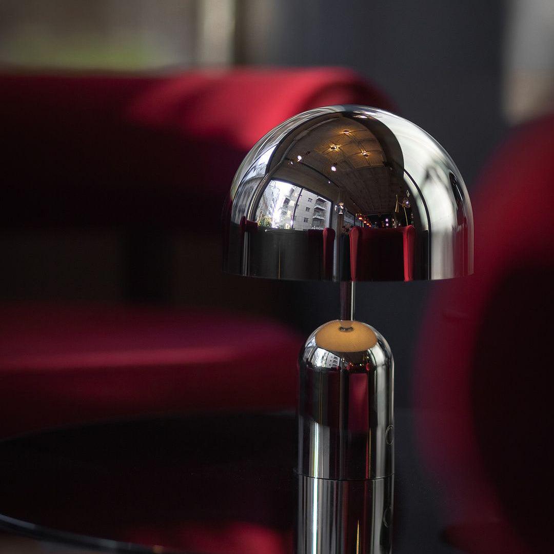 Metallic lamp with a reflective surface on a blurred background