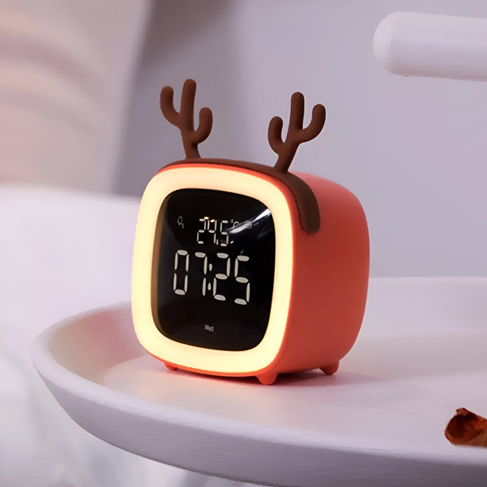 Red deer-shaped digital clock on a white surface with a blurred background