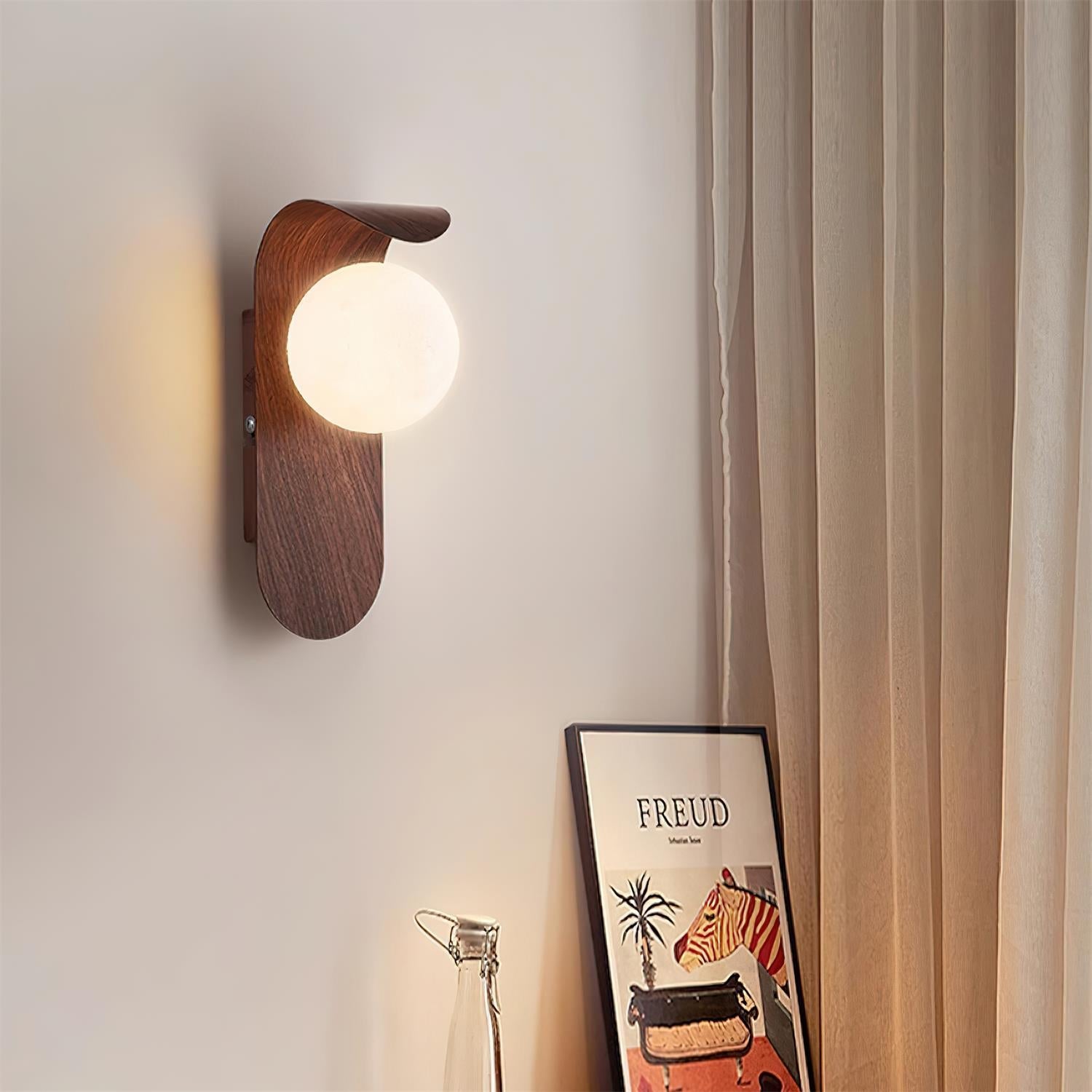 Wooden wall sconce with a light bulb on a neutral wall.