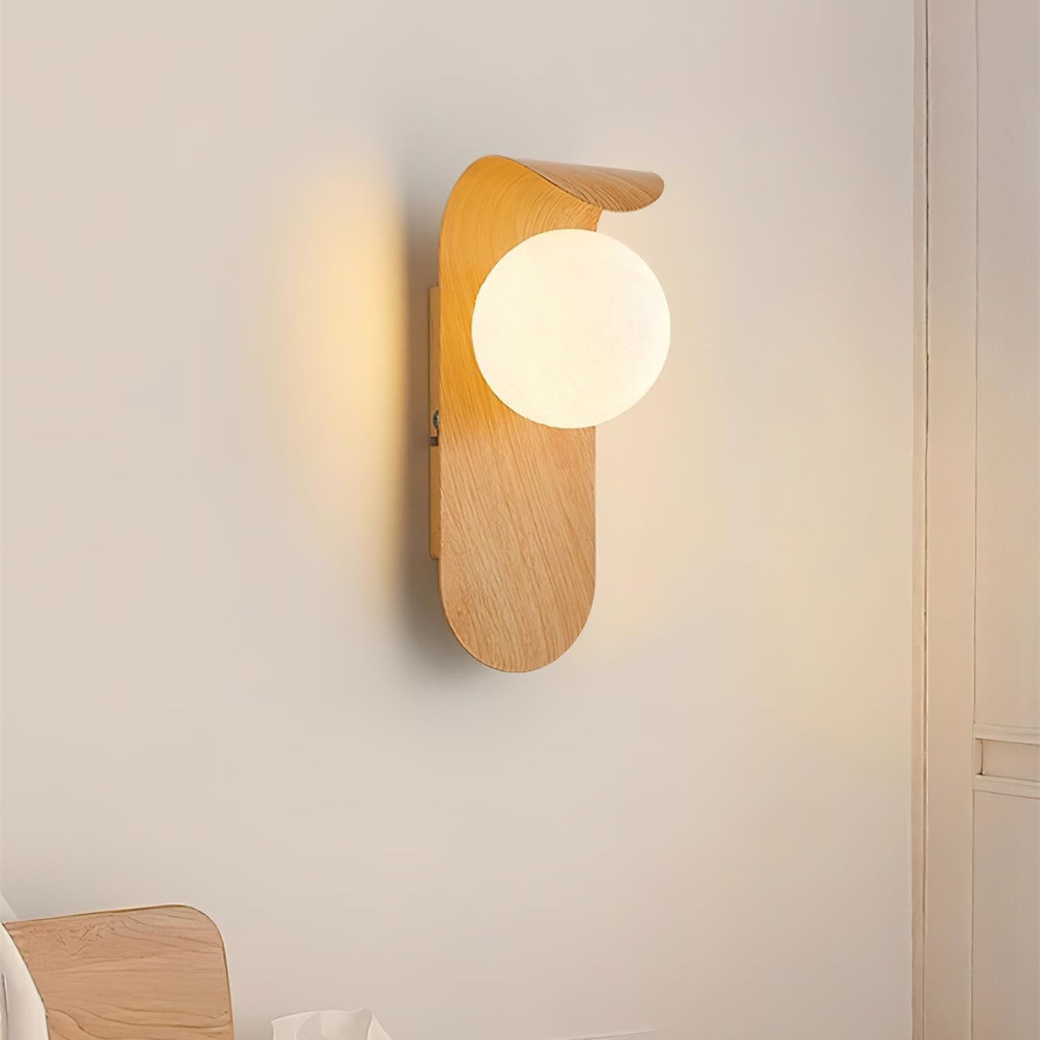 Wooden wall lamp on a light gray wall with a minimalistic setup.