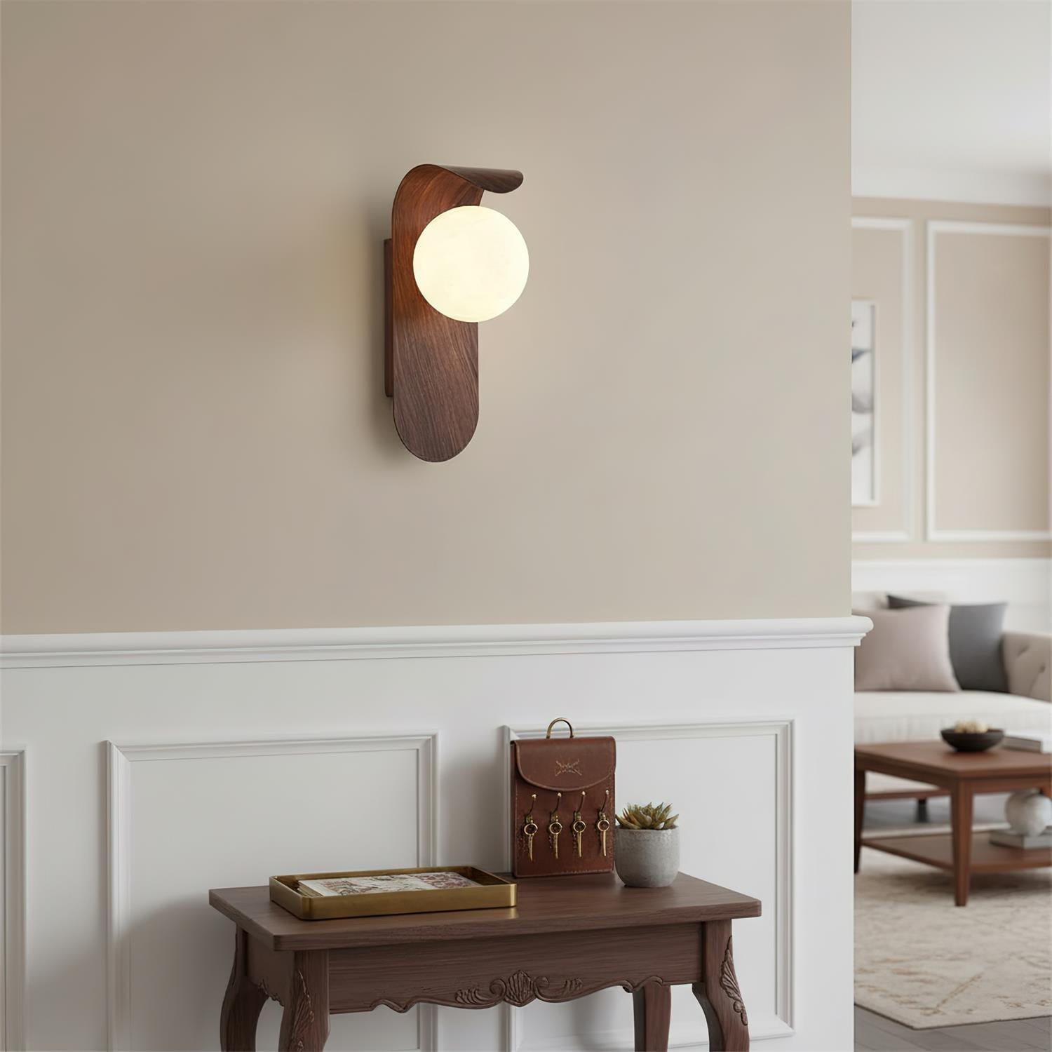 Wooden wall sconce on a beige wall with a living room in the background