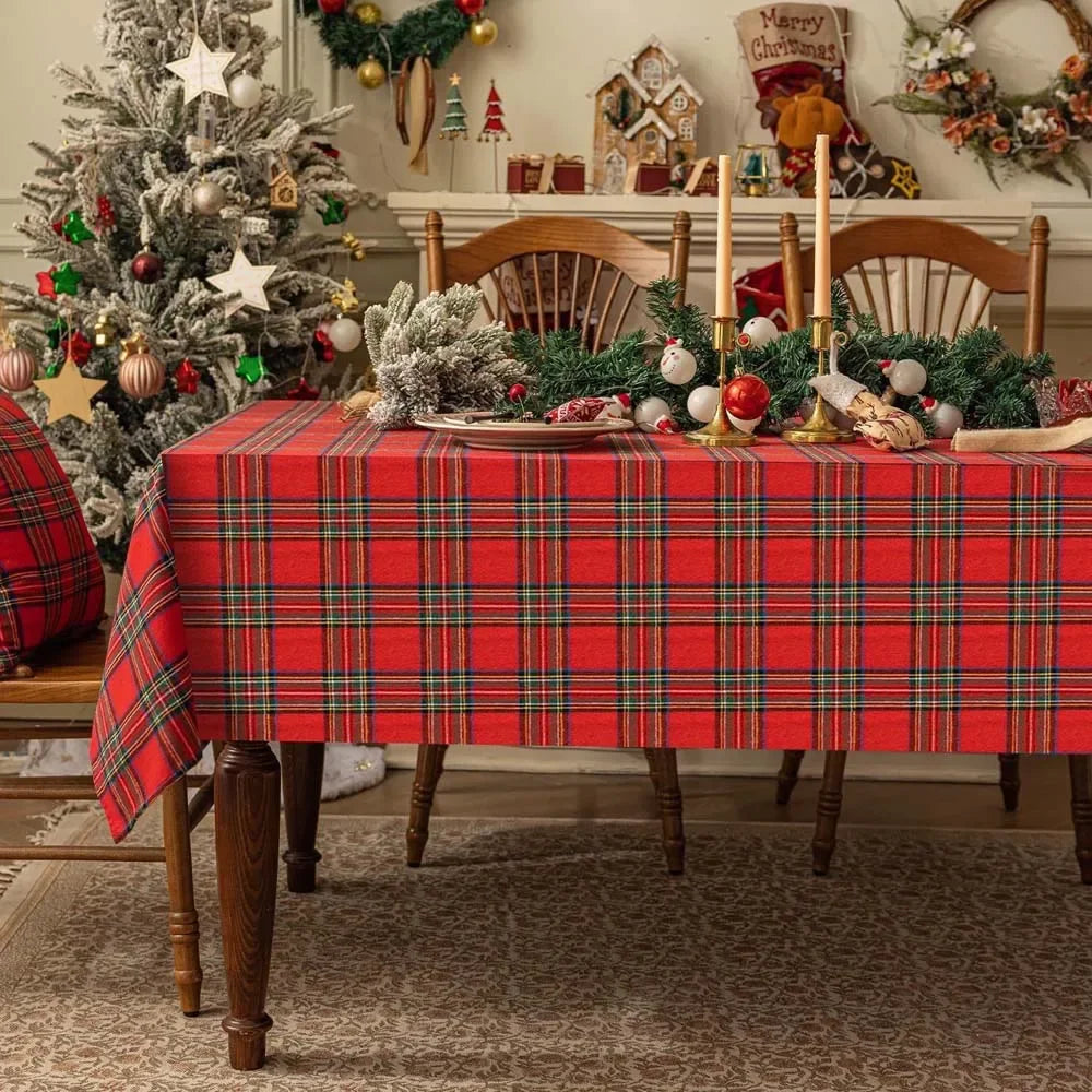 Dining room with a Christmas tree and table set for a meal, featuring a red plaid tablecloth.