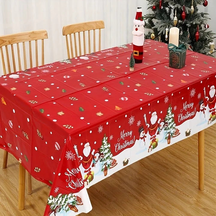 Christmas-themed tablecloth with Santa Claus, reindeer, and trees on a wooden table.