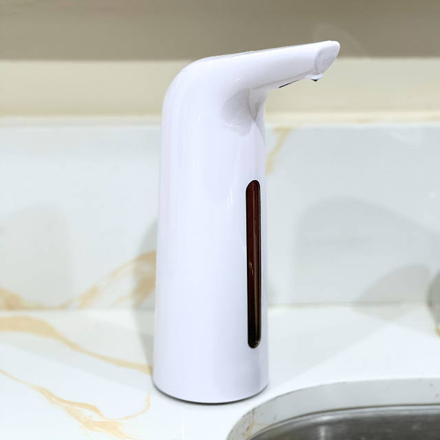 White soap dispenser on a marble countertop