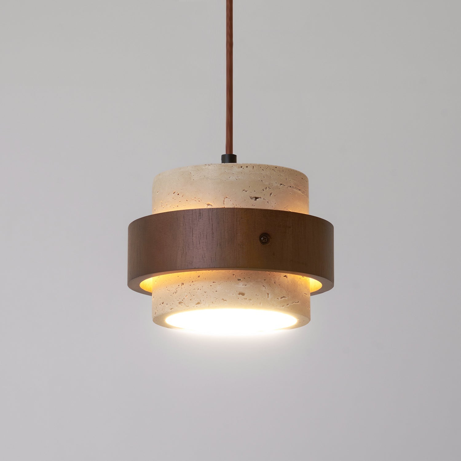 Modern pendant light with concrete and wood design on a gray background