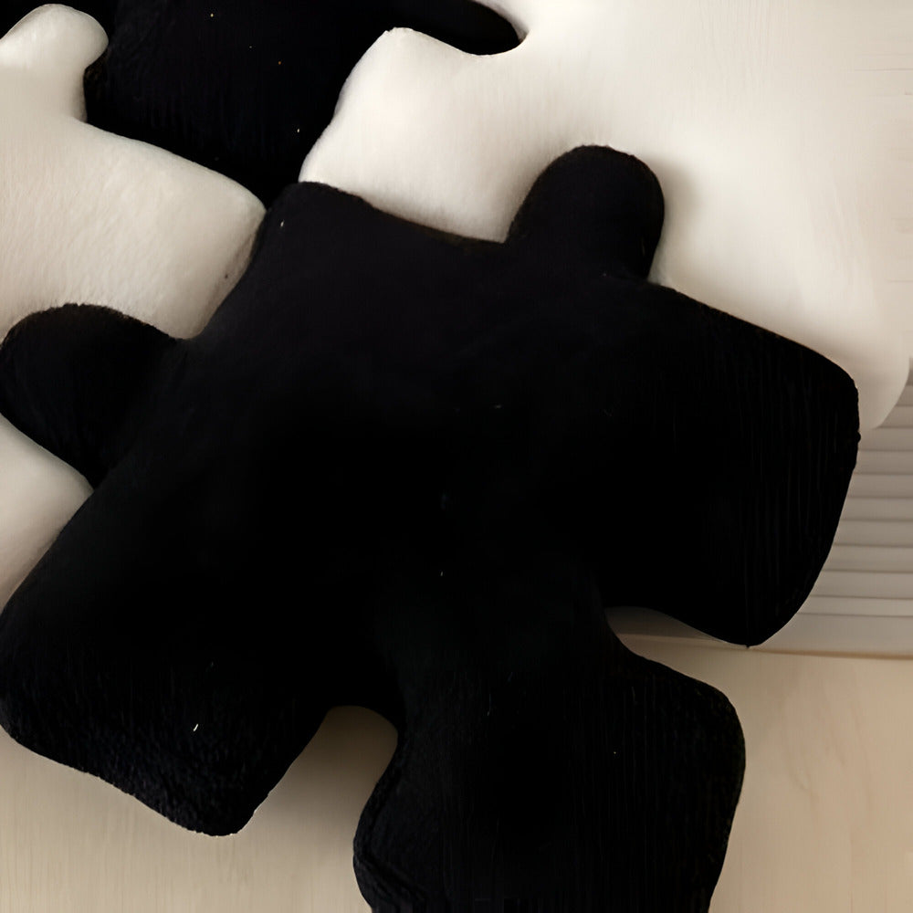 Black teddy bear on a white surface