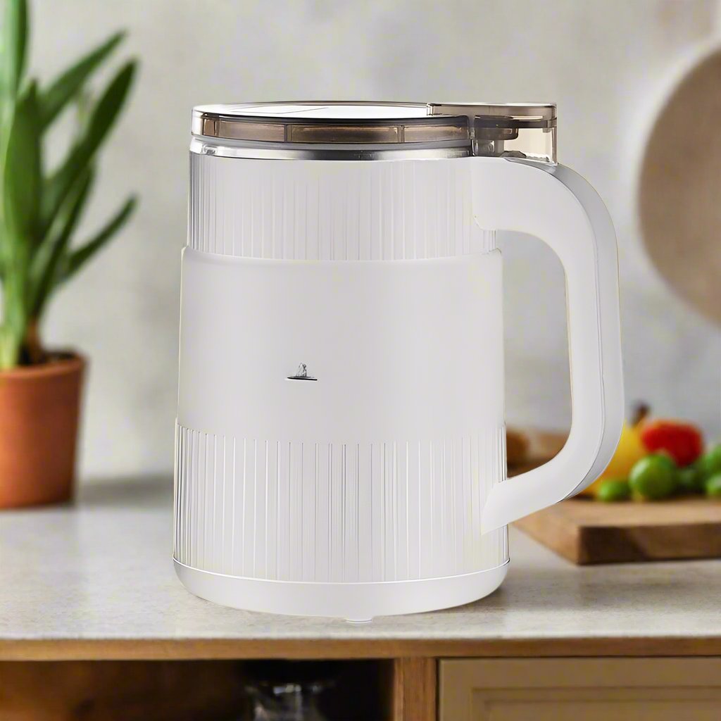 White electric kettle on a kitchen counter with a blurred background