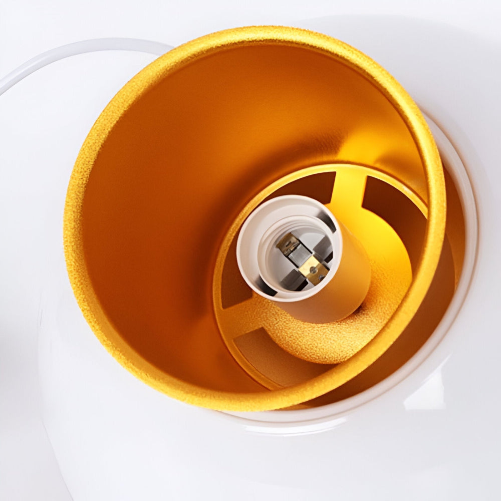 Close-up of a yellow lampshade with a white socket inside on a white background
