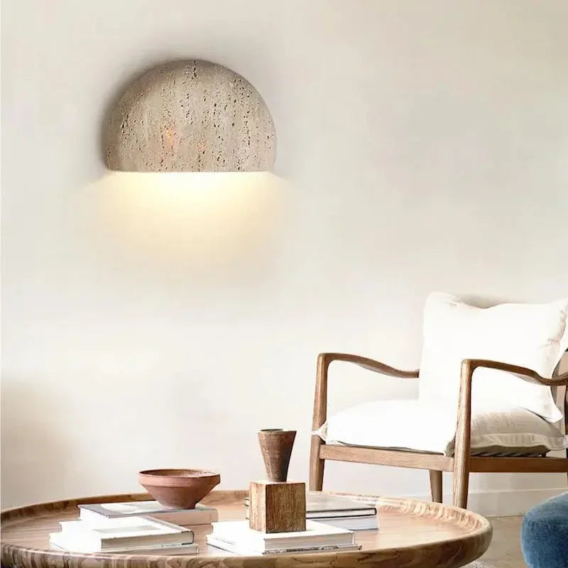 Modern interior with a concrete pendant light, wooden table, and chair.