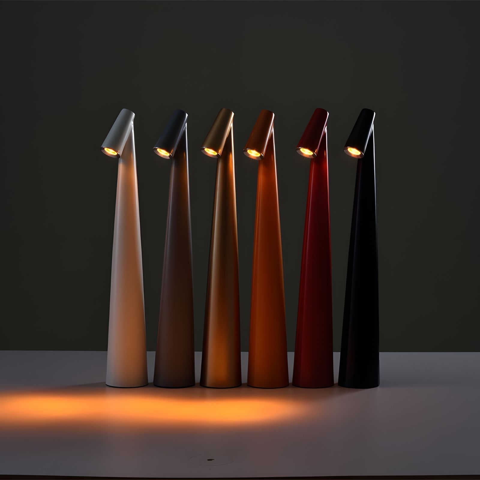 Set of six modern table lamps in different colors on a dark background