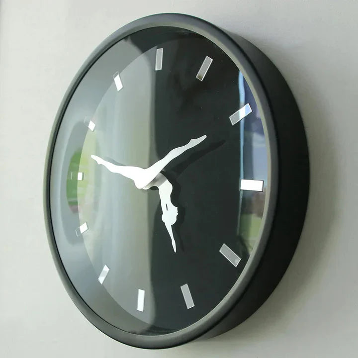 Round wall clock with black face and silver accents on a white wall