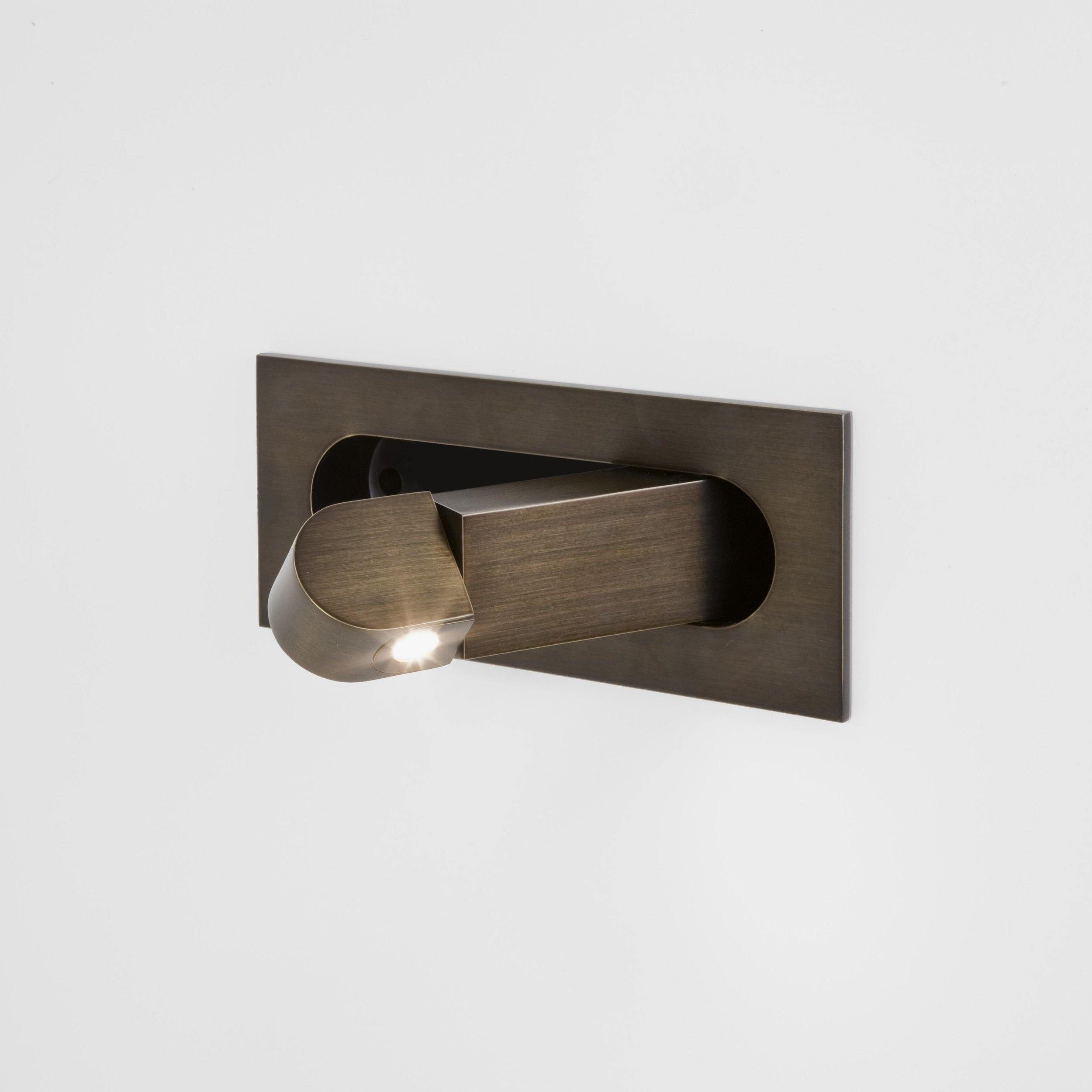 Bronze wall-mounted light fixture on a white background
