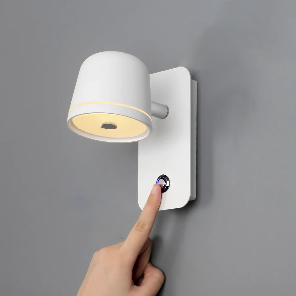 Wall-mounted light fixture with a button being pressed on a gray background