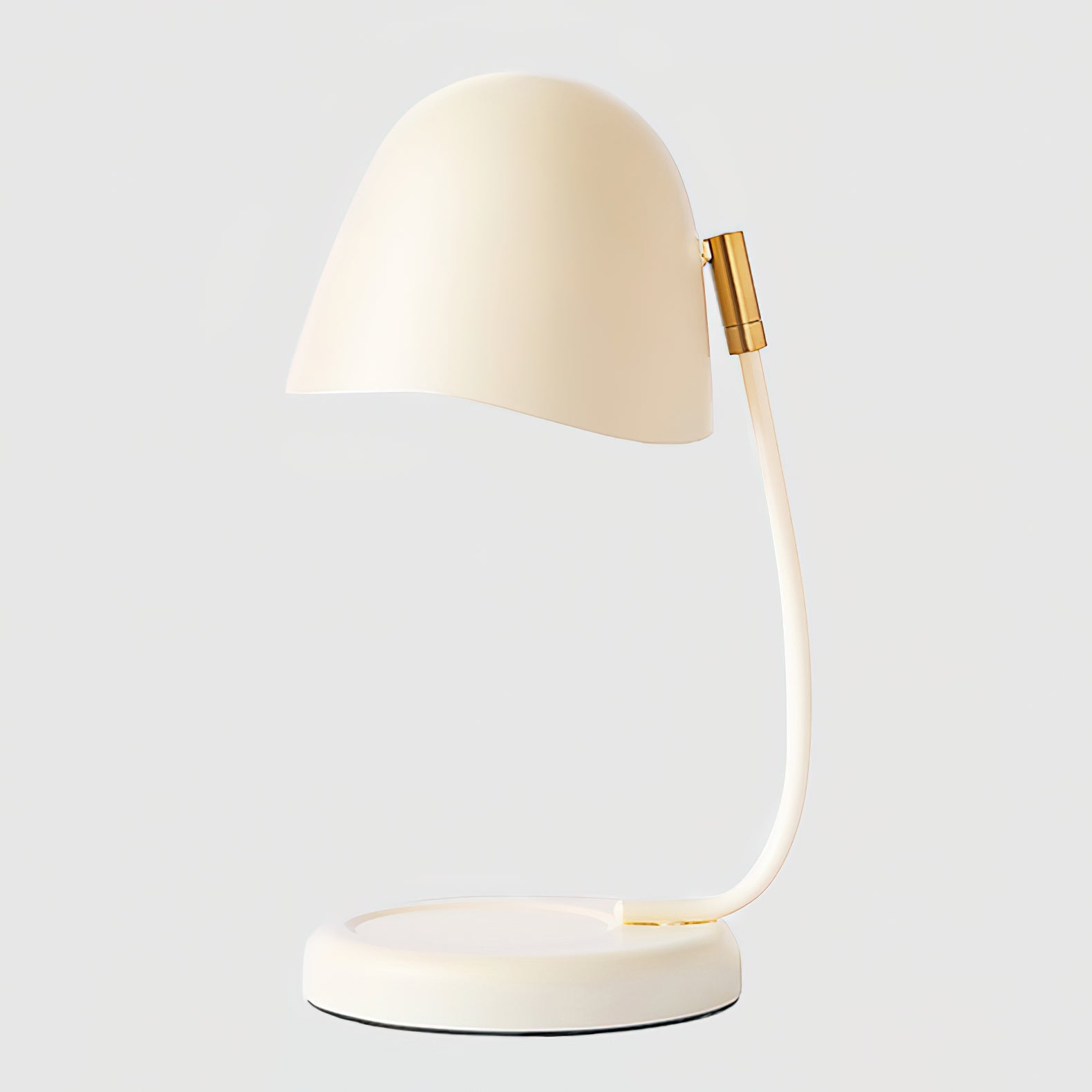 Modern desk lamp with a cream-colored shade and base on a light gray background