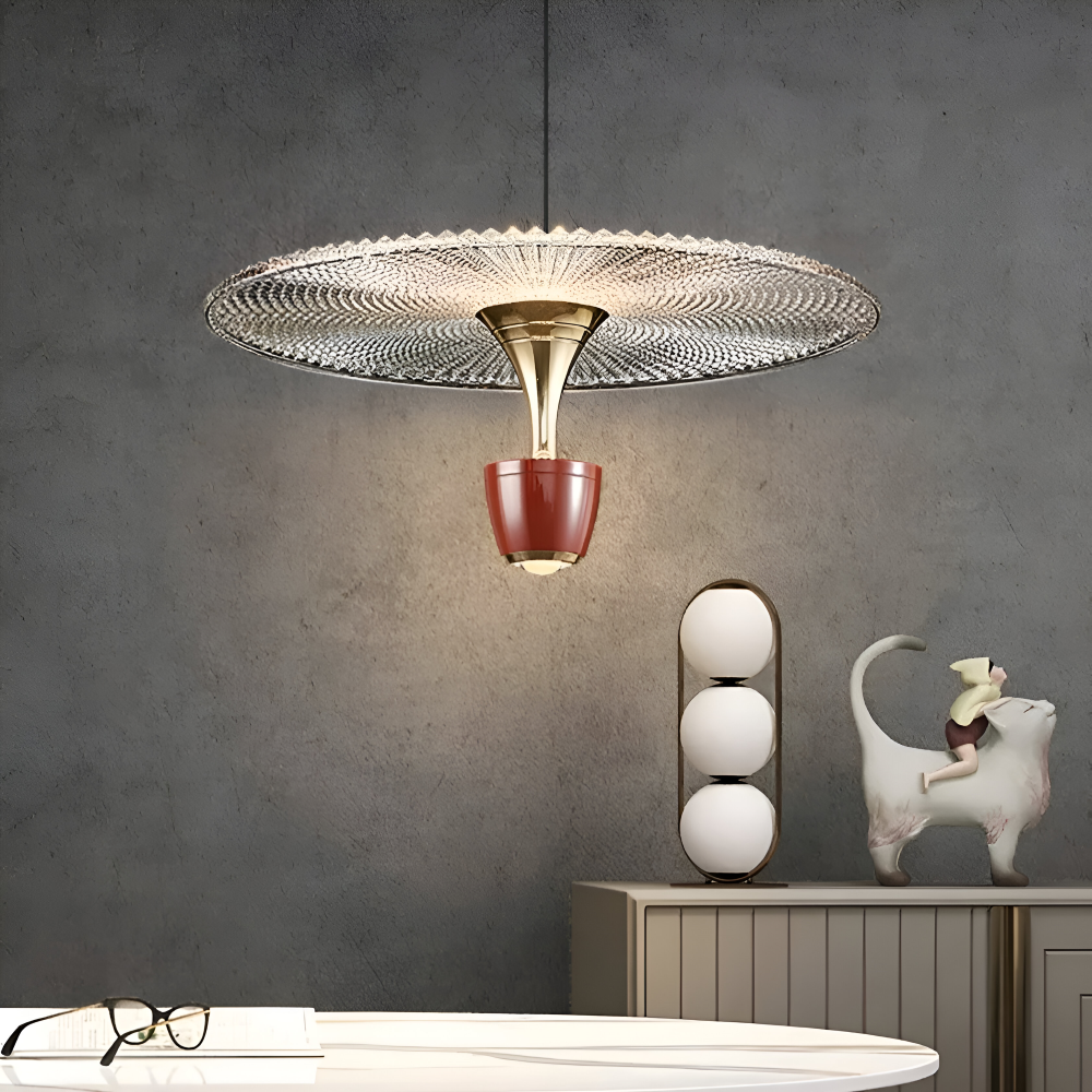 Modern pendant light fixture with decorative design in a room setting.