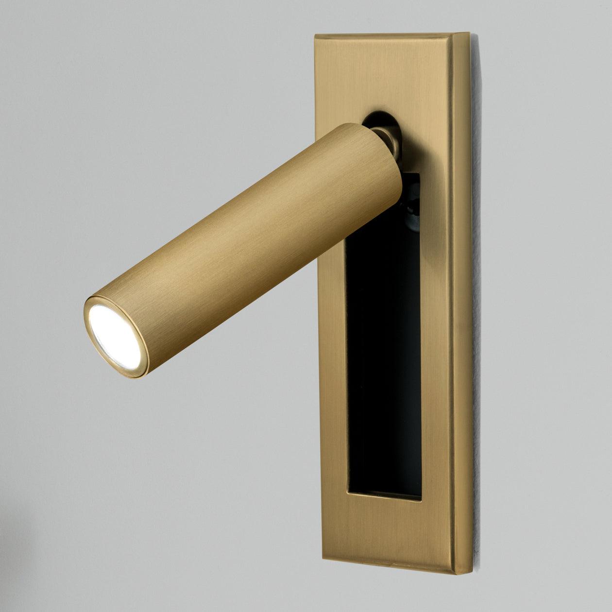 Gold door handle with light on a gray background