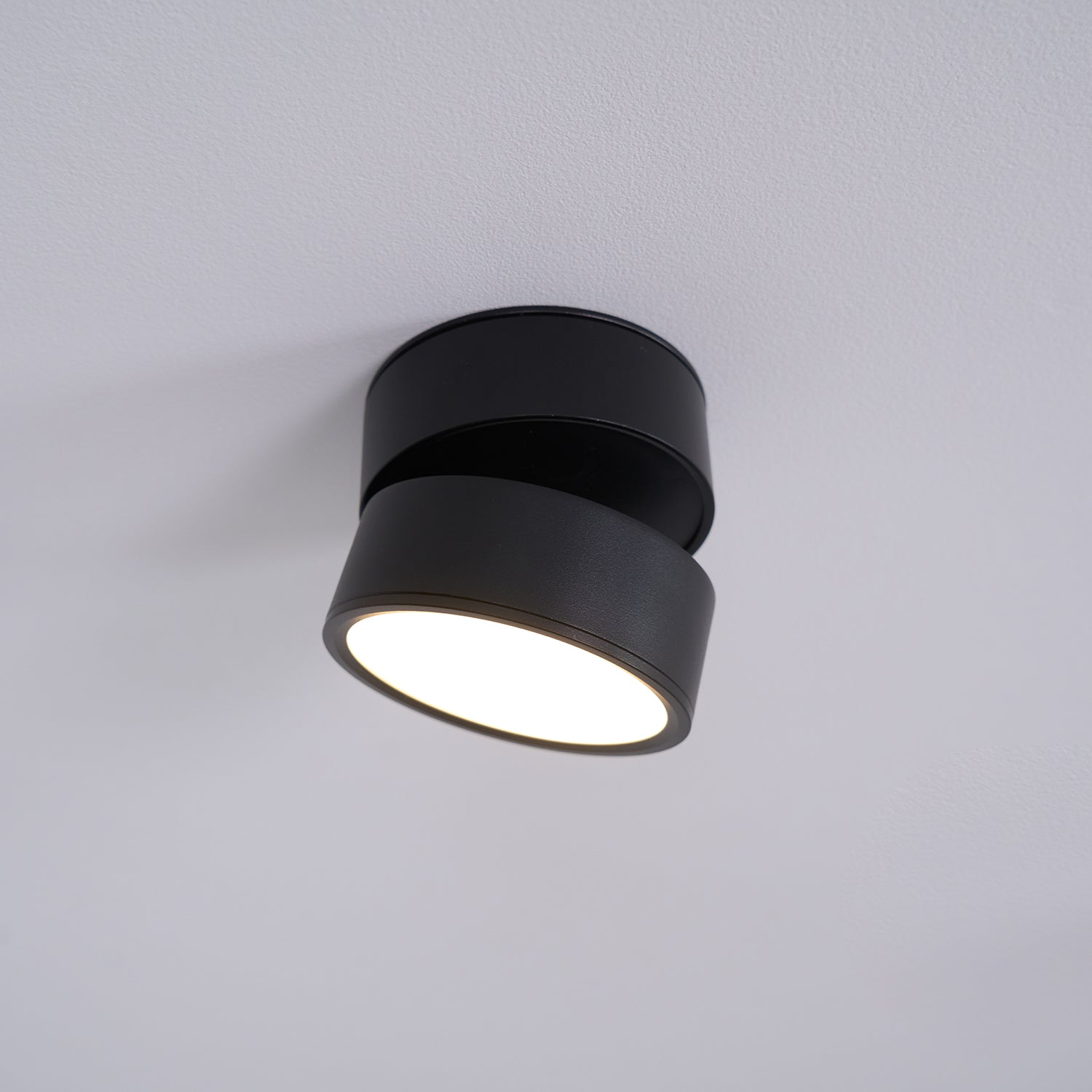 Black ceiling light fixture on a gray background