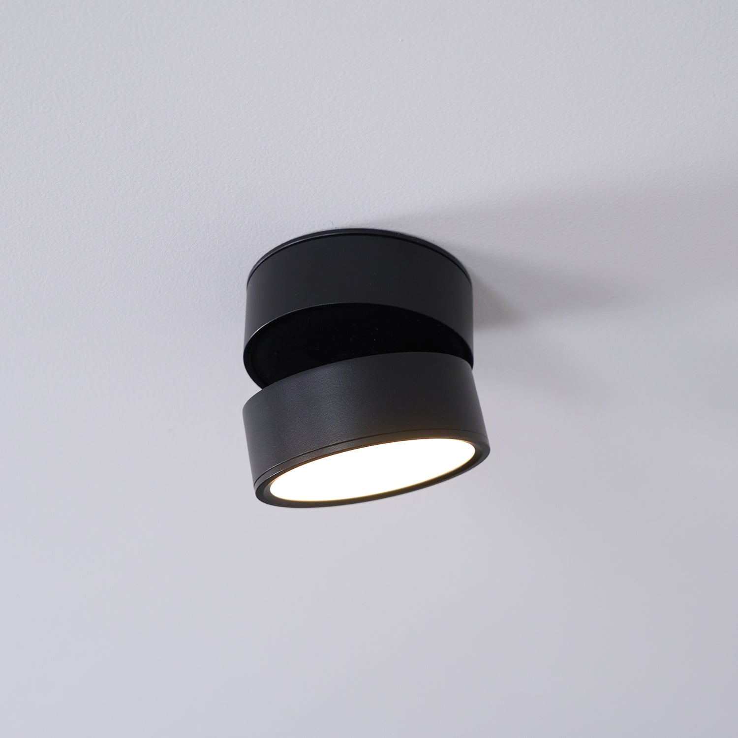 Black ceiling light fixture on a gray background