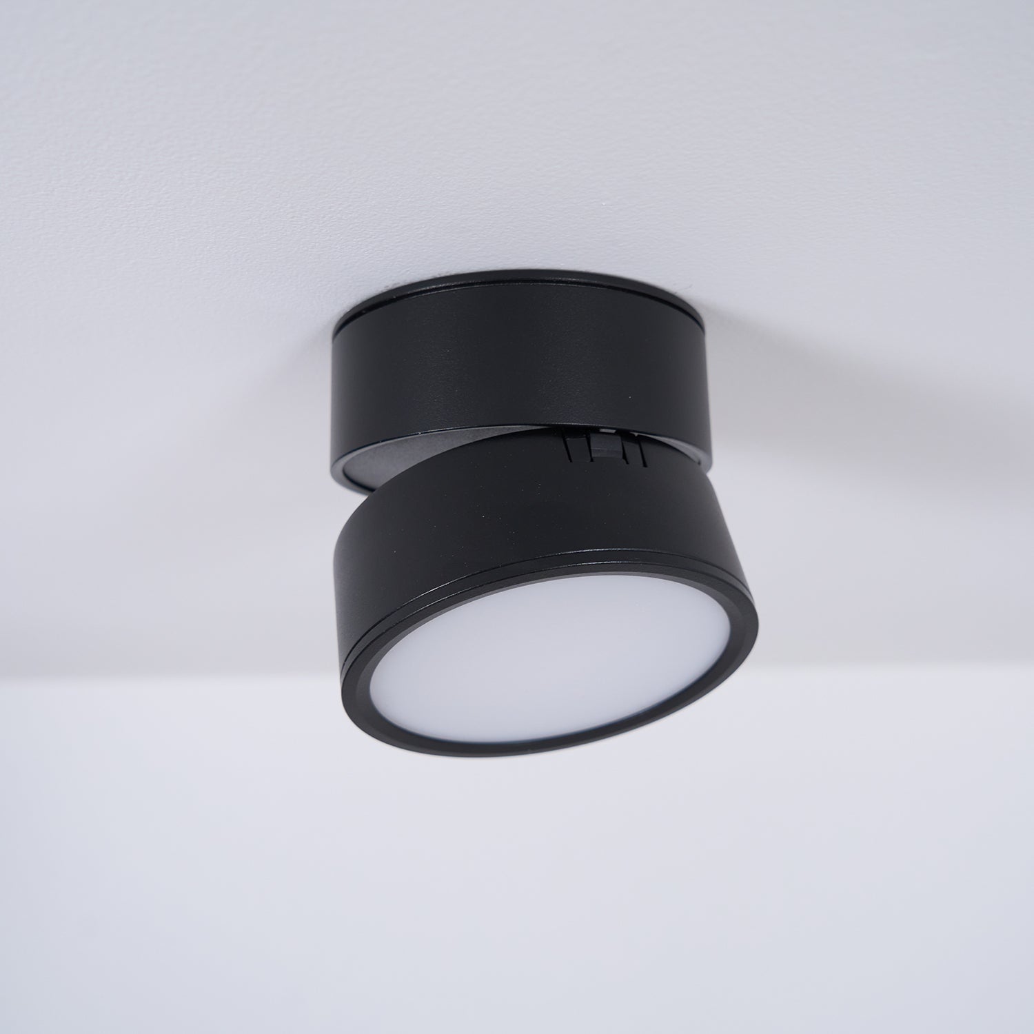 Black ceiling light fixture on a white background