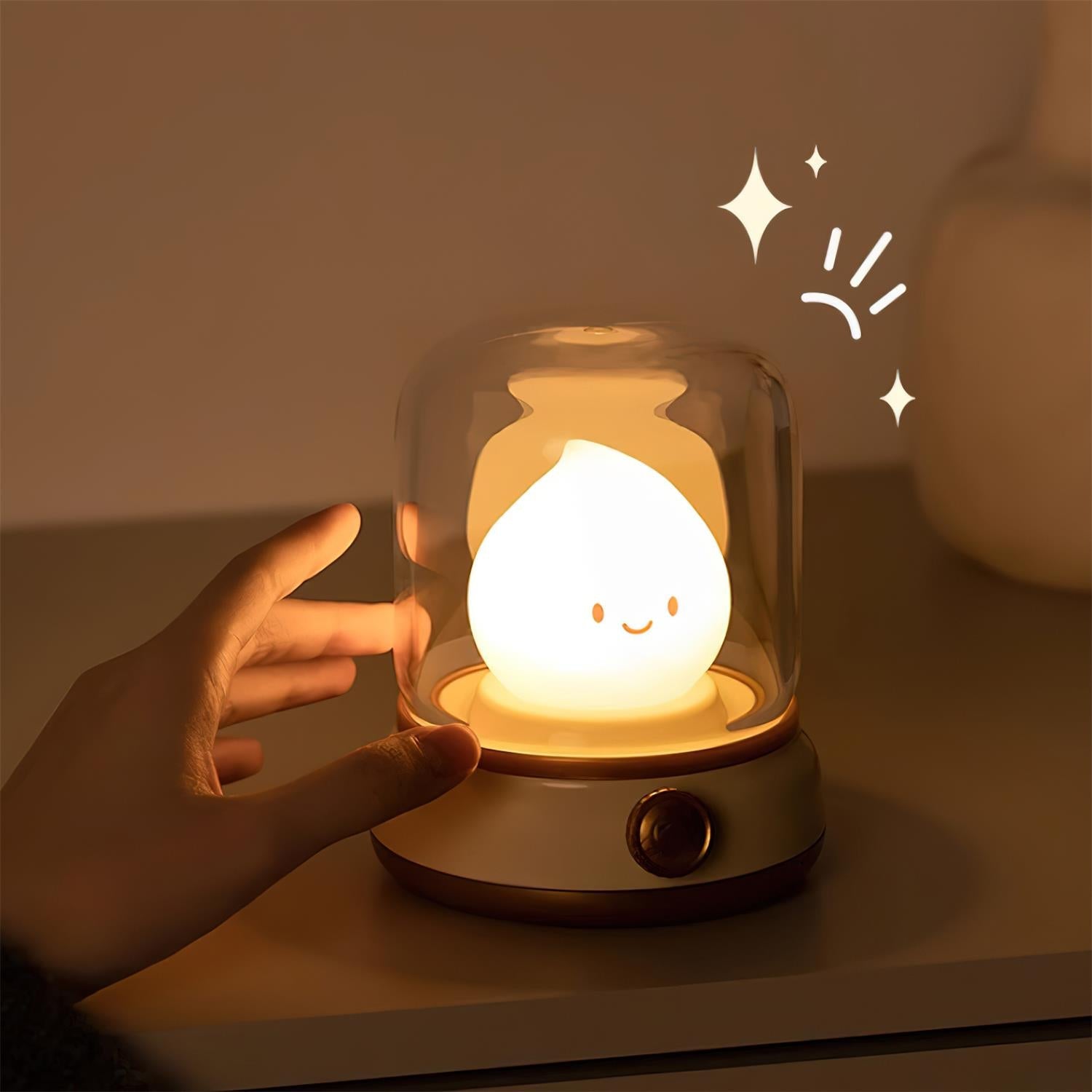 Cute lamp with a smiling face inside a glass dome, held by a hand on a warm-toned background.