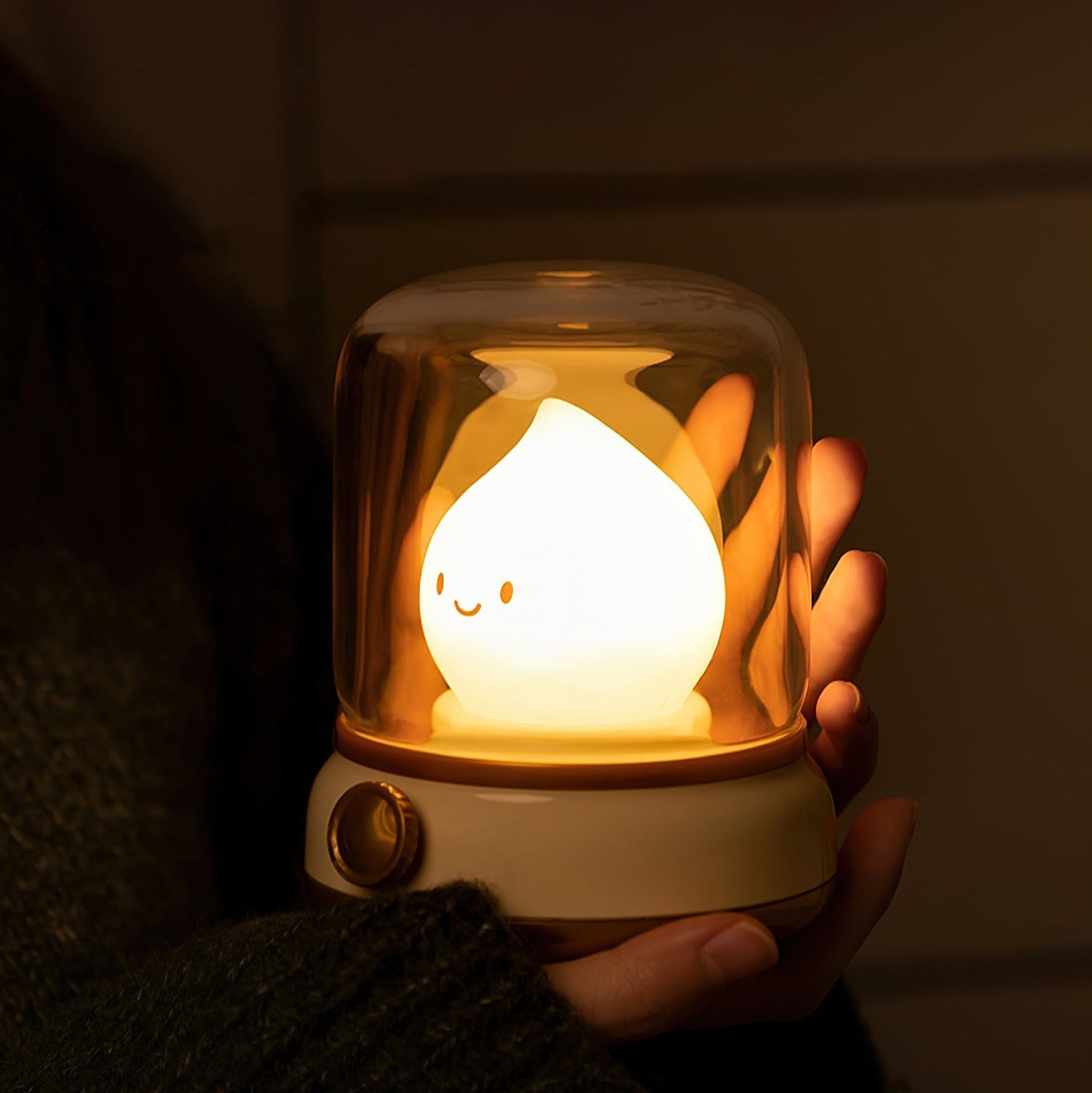 Cute night light held in a hand with a dark background