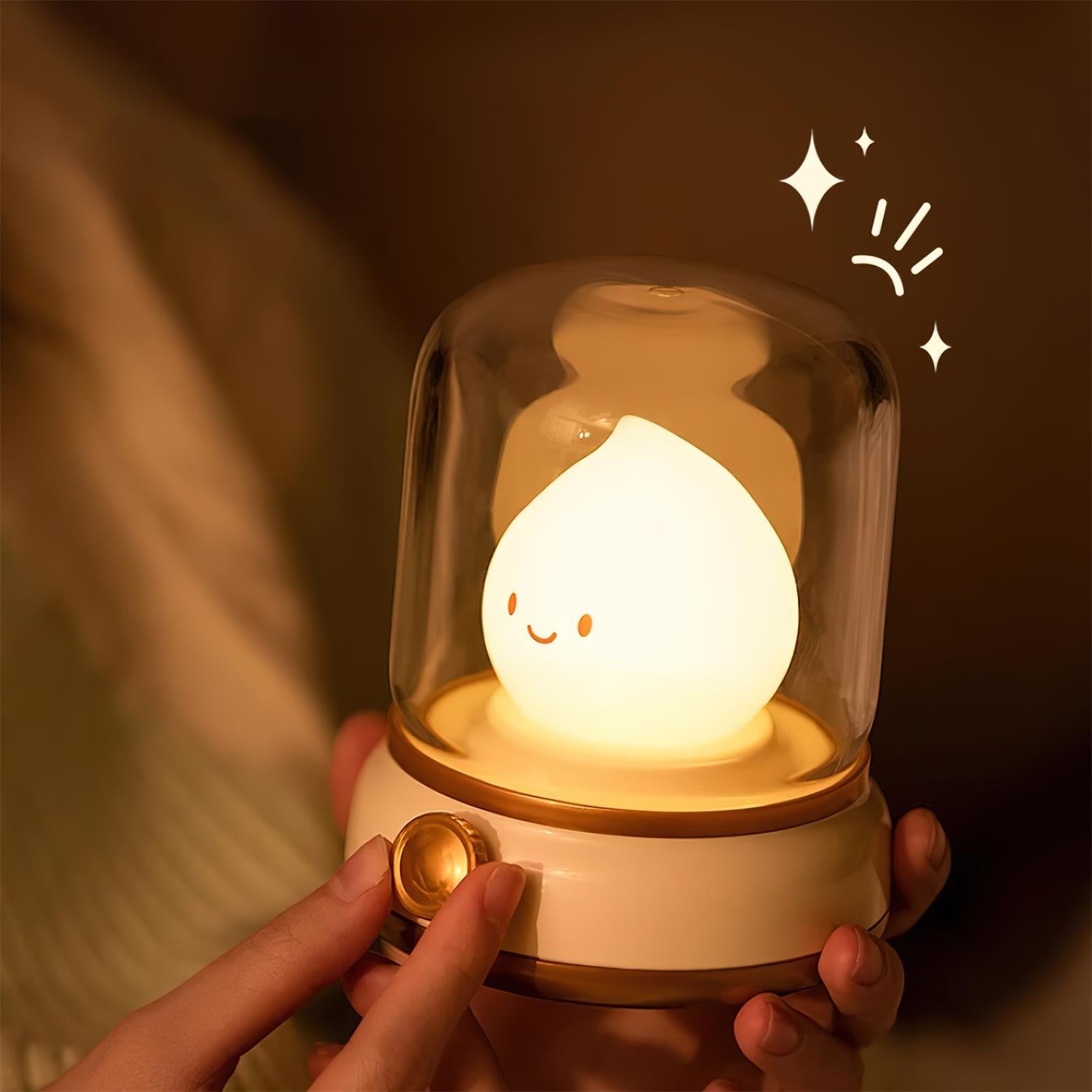 Cute lamp with a smiling face inside a glass dome, held by a hand.