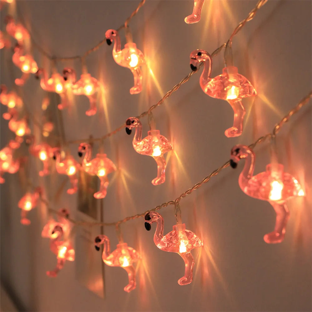 String lights with flamingo decorations on a dark background