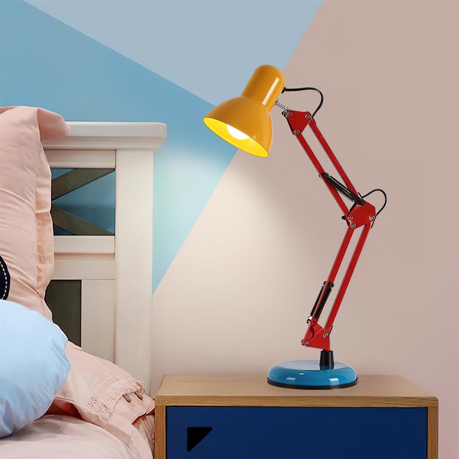 Colorful lamp on a nightstand with a bed and blue wall in the background