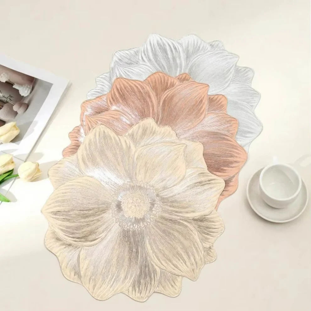 Floral-patterned placemats on a table with a cup and saucer in the background.