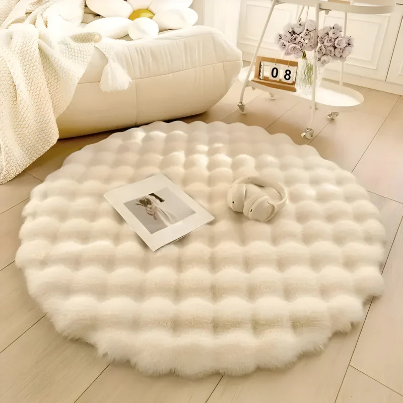 Round white fluffy rug on a wooden floor with a photo and headphones on top