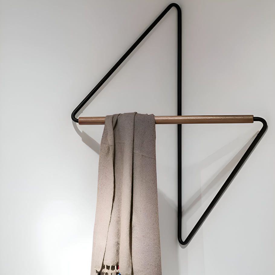Wall-mounted coat rack with a scarf hanging on it against a white wall
