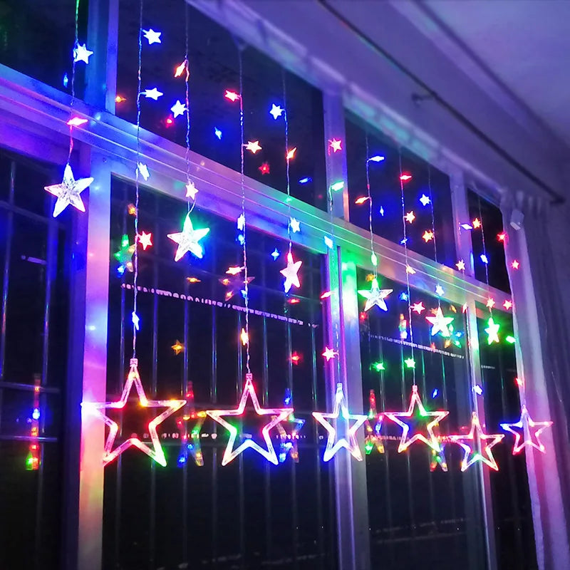Colorful star-shaped string lights on a window at night