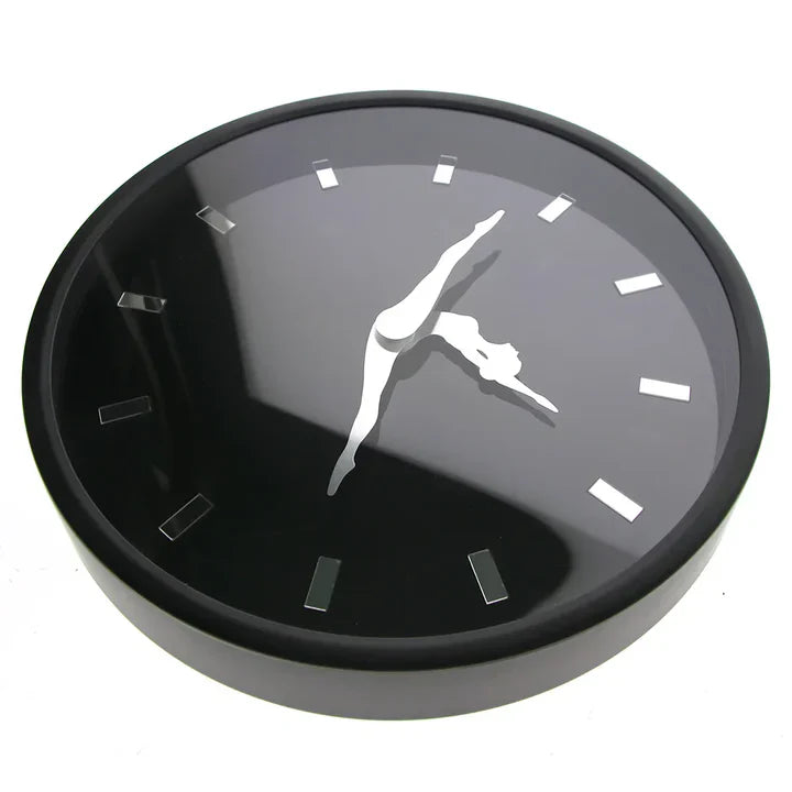 Black wall clock with a silhouette of a dancer on a white background