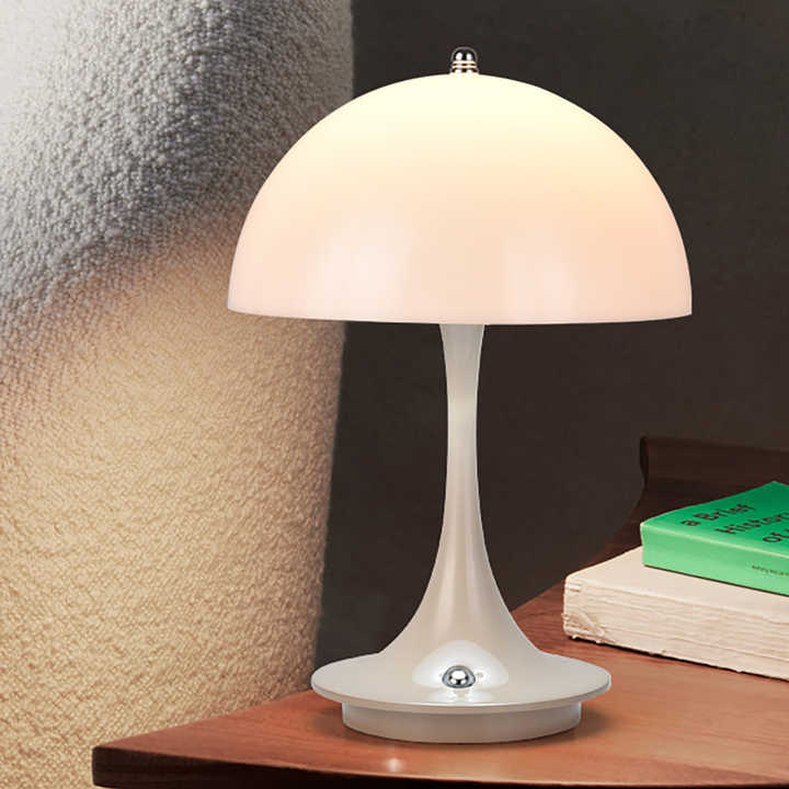 Table lamp on a wooden surface with a textured wall background