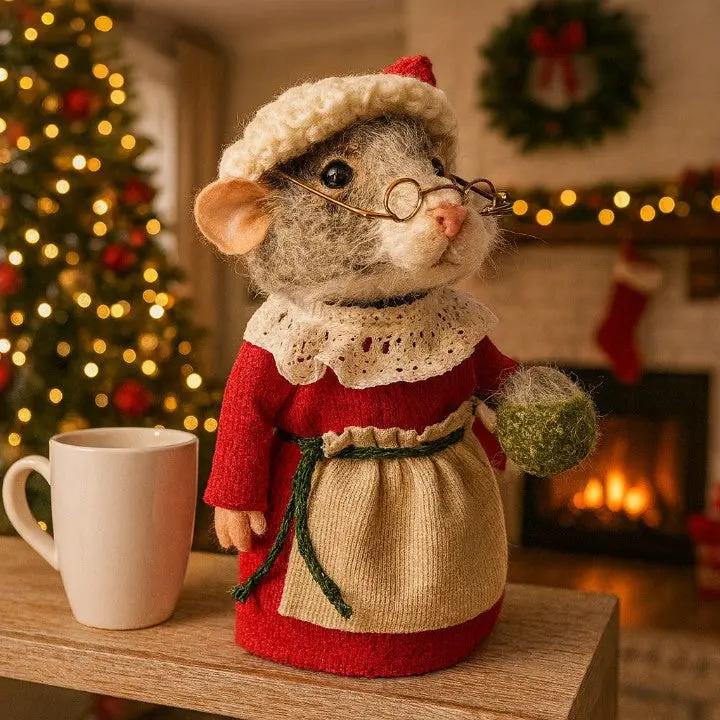 Decorative mouse figurine in a festive setting with a Christmas tree and fireplace.