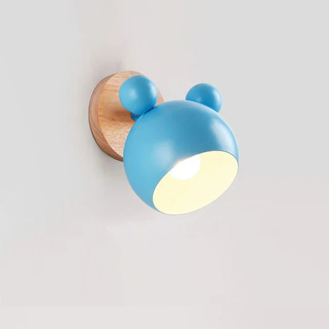 Blue wall light fixture with wooden base on a white background