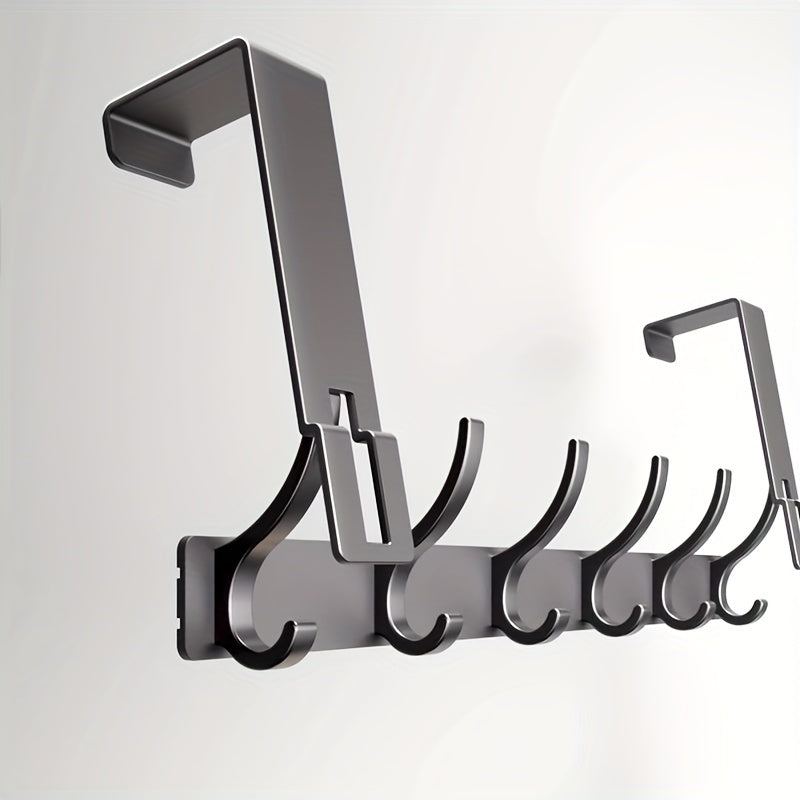 Metallic wall-mounted hook rack with multiple hooks on a light gray background