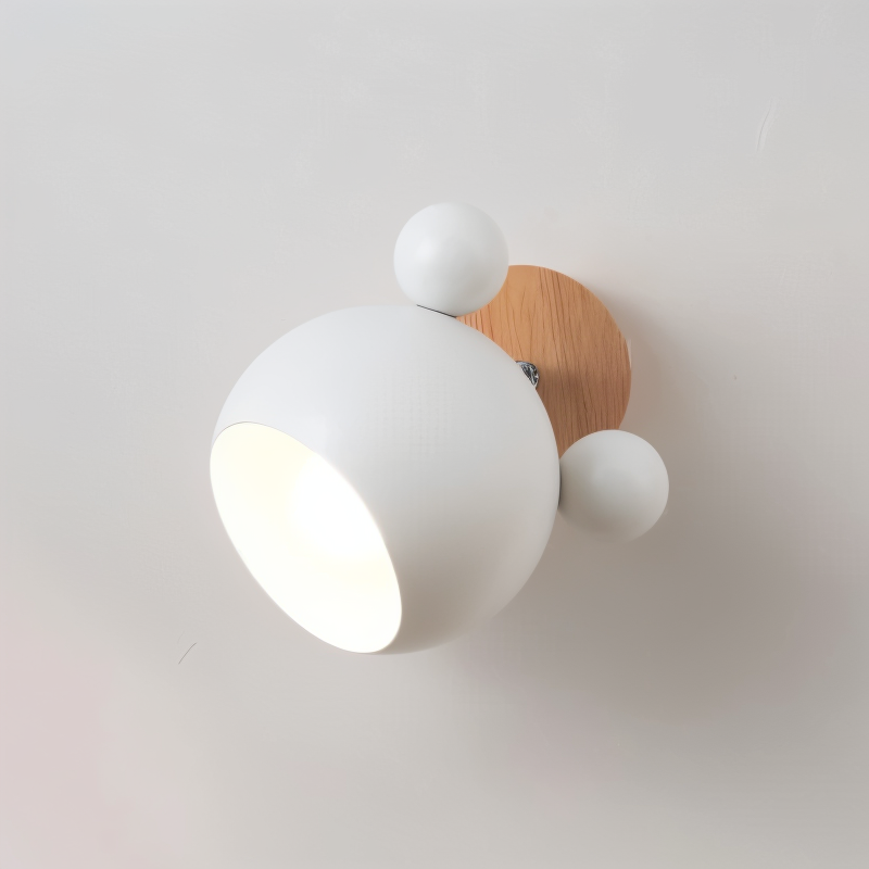Modern wall light fixture with white shades and wooden base on a plain wall.