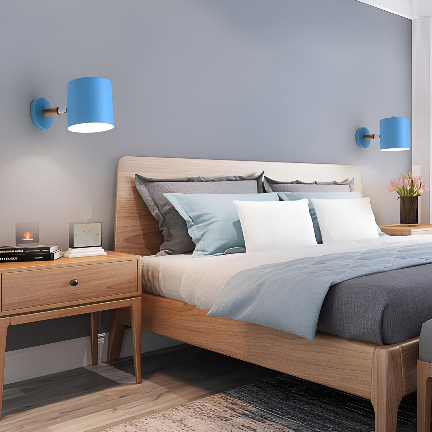 Modern bedroom with wooden bed, blue wall lamps, and decorative items.