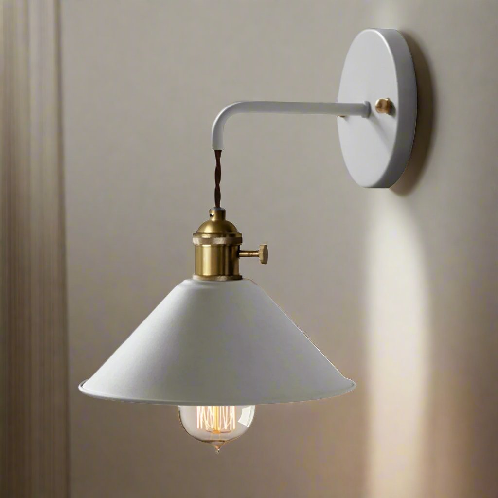 Wall-mounted lamp with white shade and brass fixture on a neutral wall.