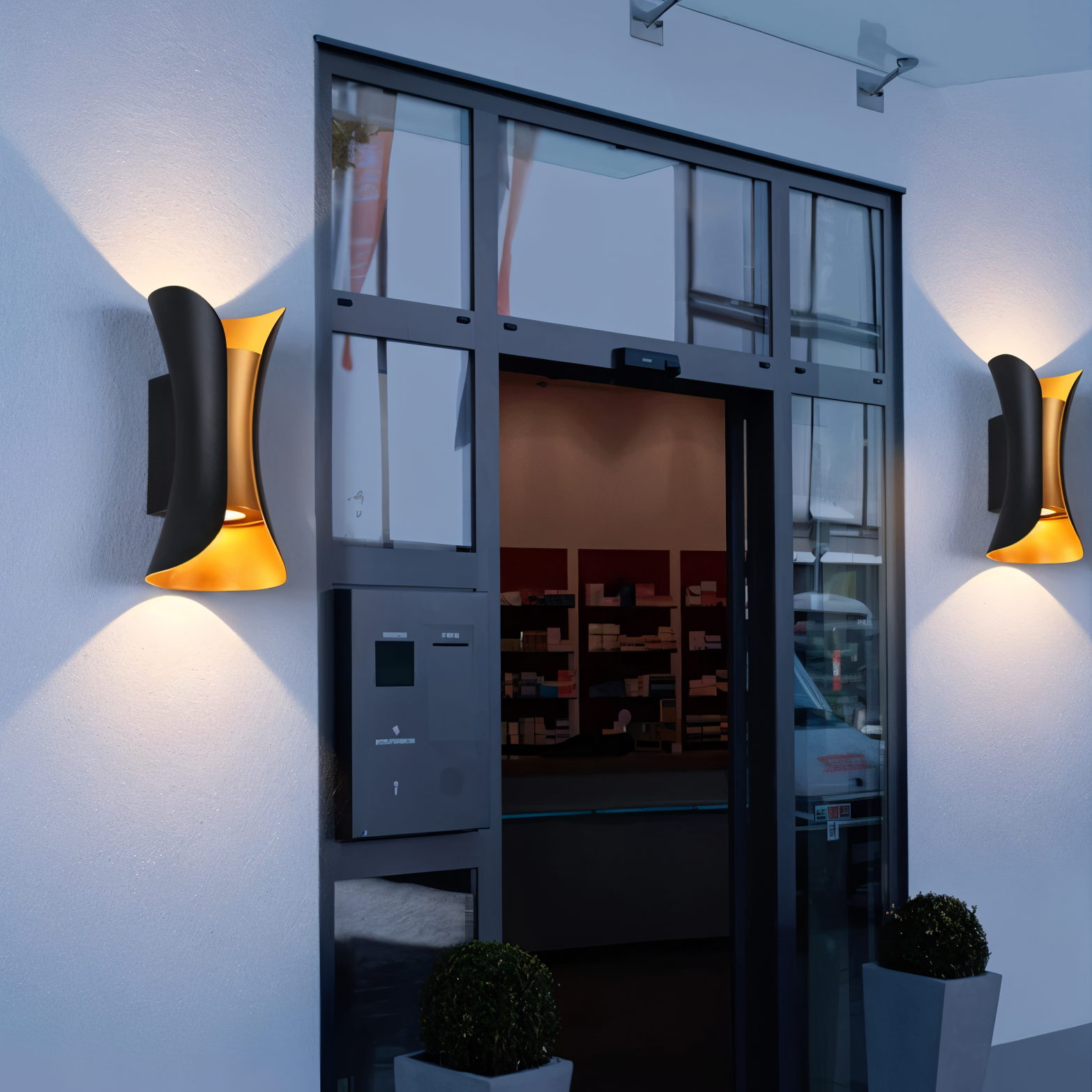 Modern wall lights on a white wall with a glass door in the background