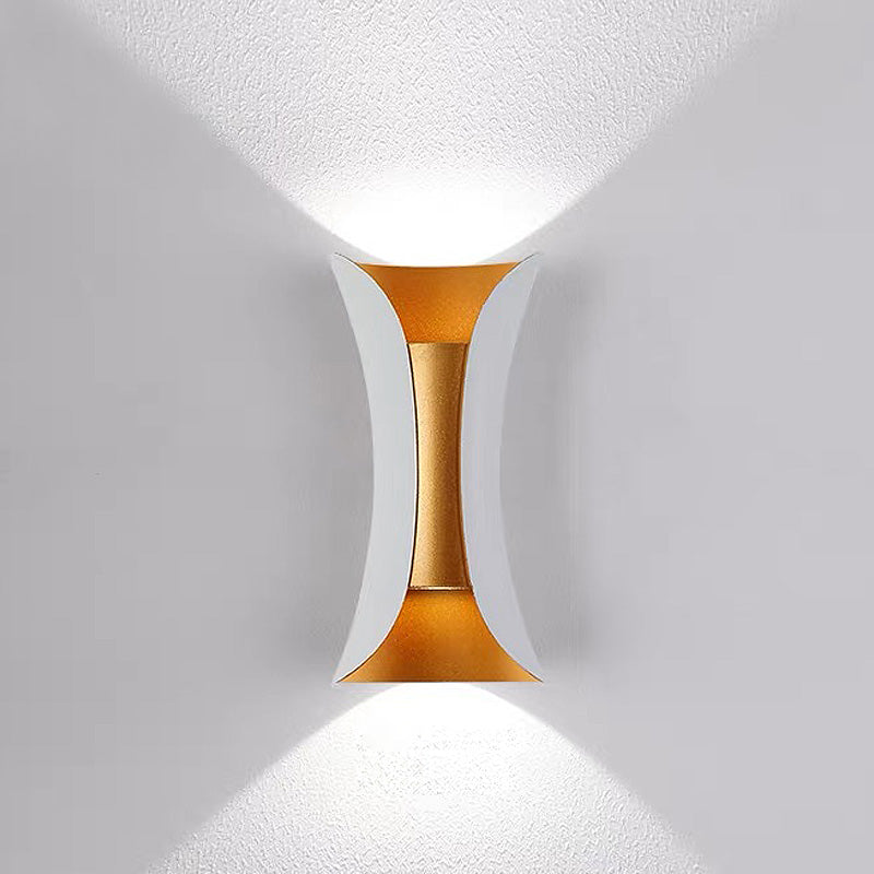 Gold wall sconce on a white wall