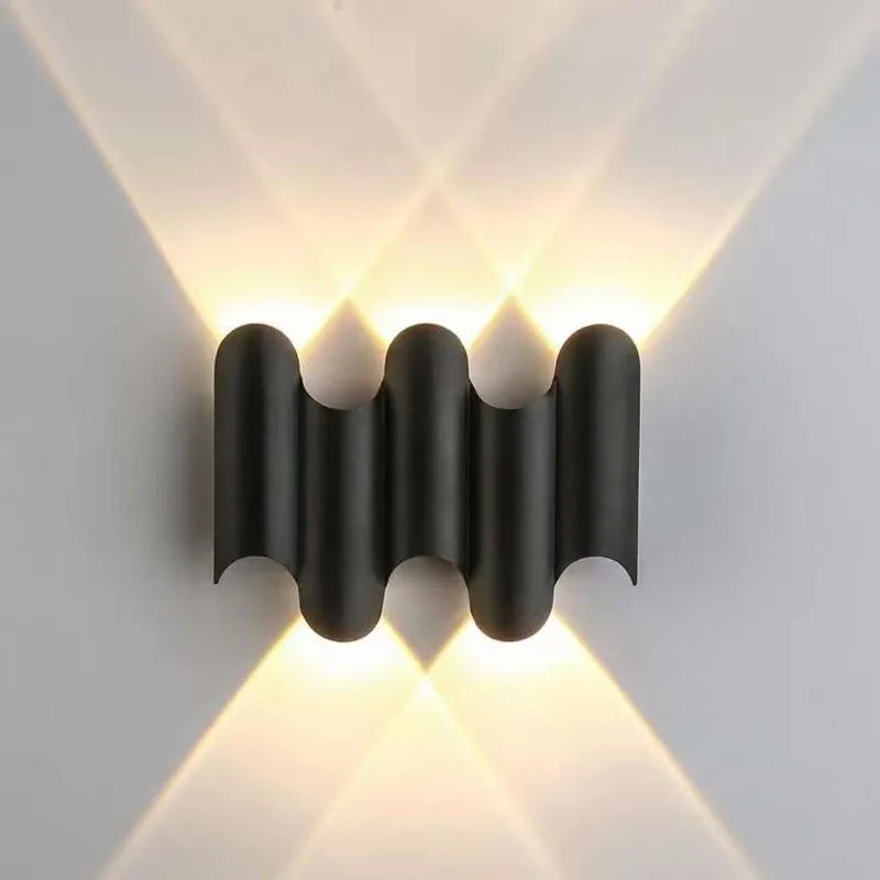 Modern black wall light fixture on a white wall