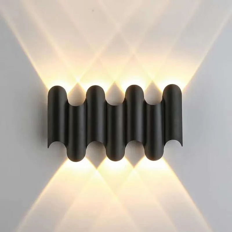 Modern wall-mounted light fixture with a ribbed design on a white wall.