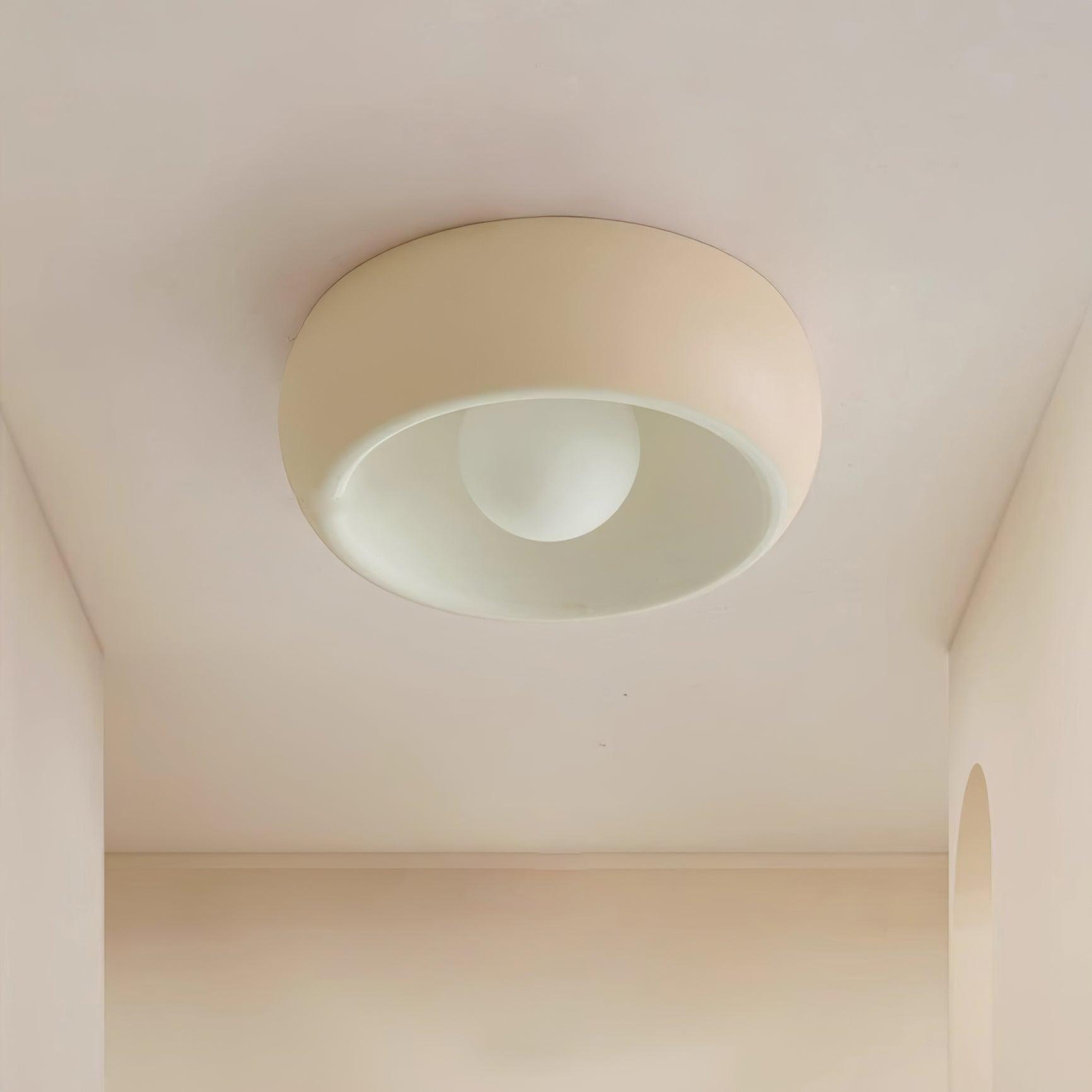 Ceiling light fixture in a room with beige walls and ceiling